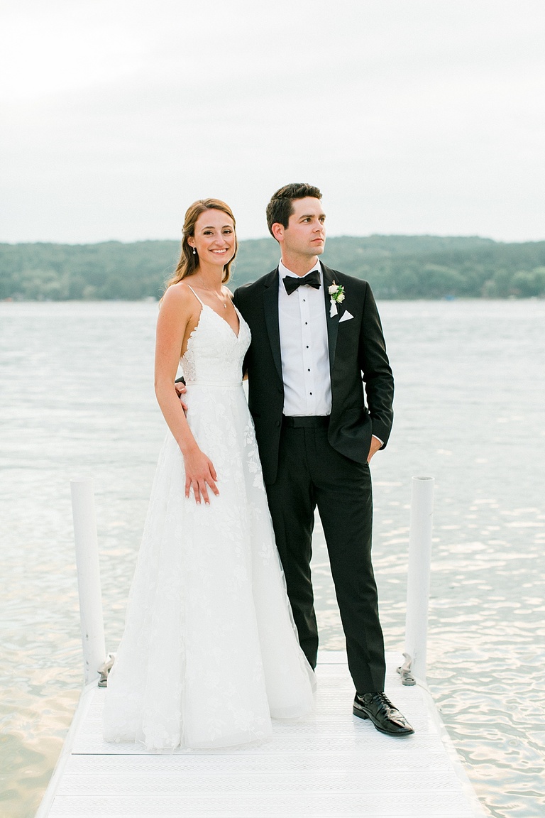Bride and groom portraits on a dock at the Walloon Lake Country Club during sunset