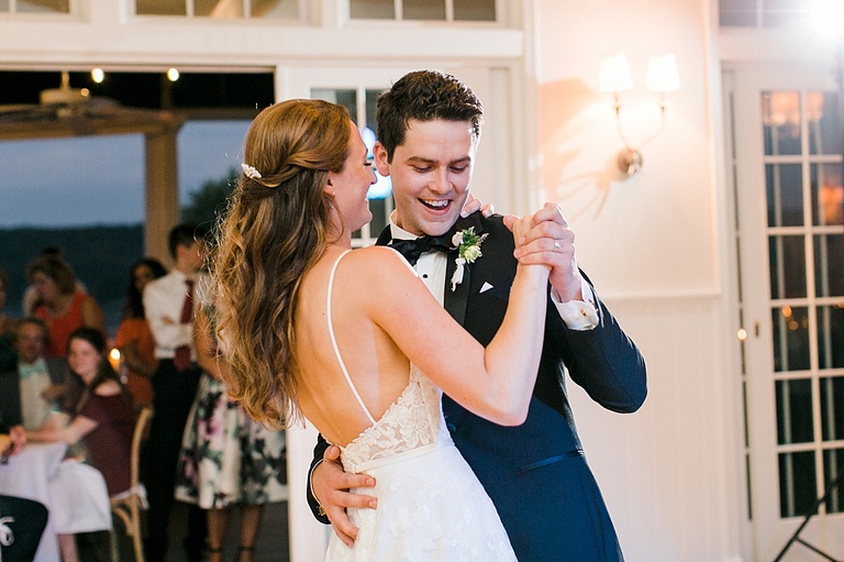 A bride and groom smiling together during their first dance