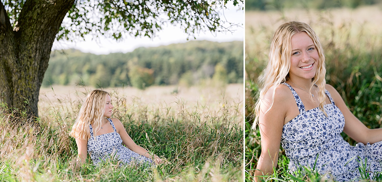 A high school senior poses for portraits in the tall grass in a field in summer