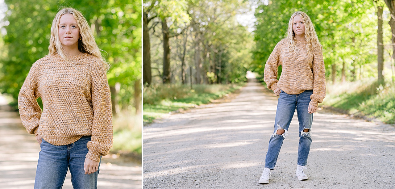 A girl poses for Michigan high school senior portraits on a country road