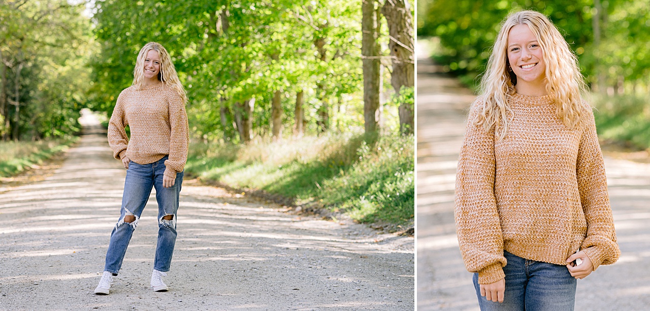 A high school girl poses in jeans on a dirt road in northern Michigan