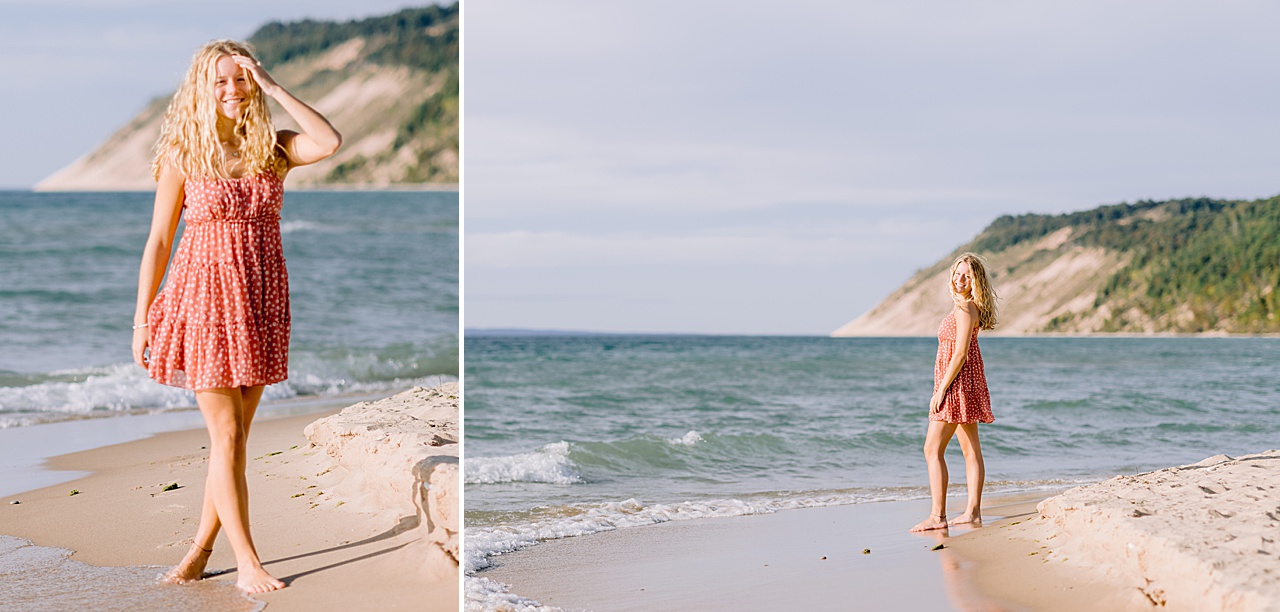 A high school girl walking on the beach with sandy dunes in the background