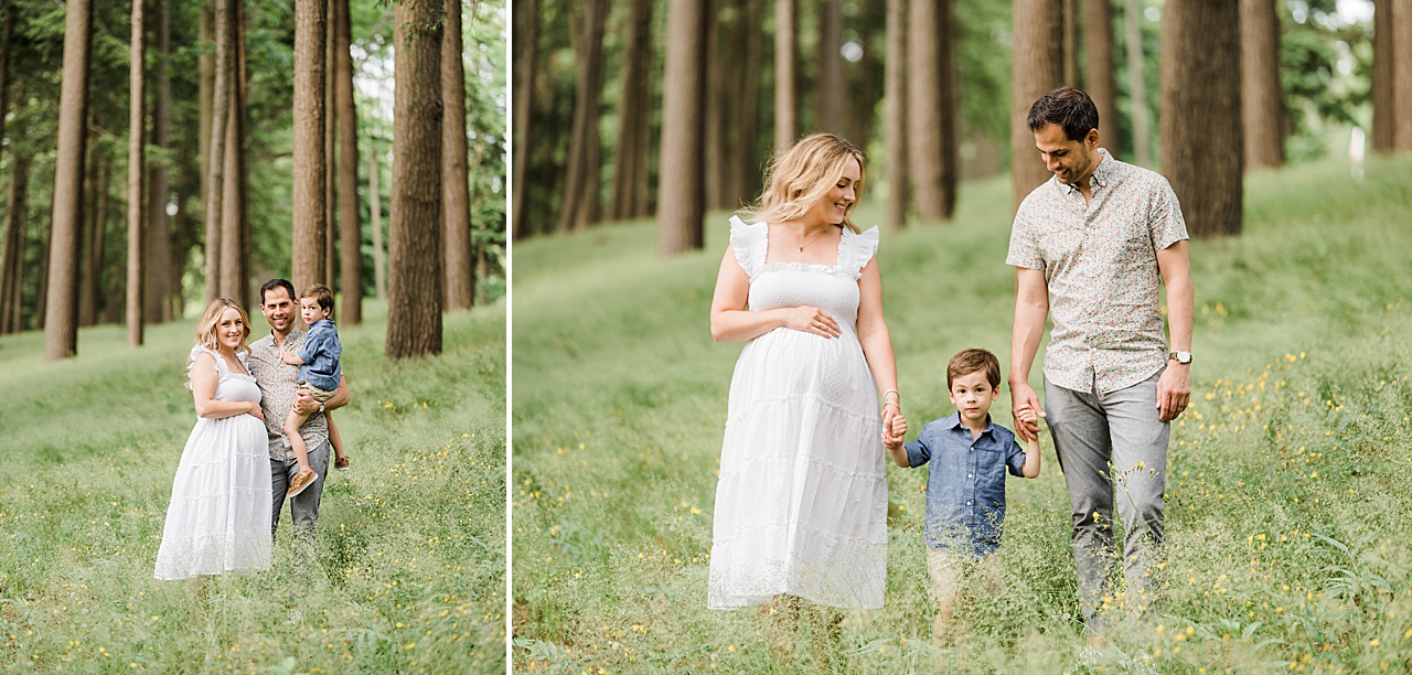 A pregnant mother in a white dress and a father hold their sons hands while walking