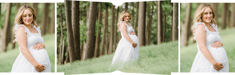 A woman in a white dress poses for maternity portraits in a wooded field in Michigan