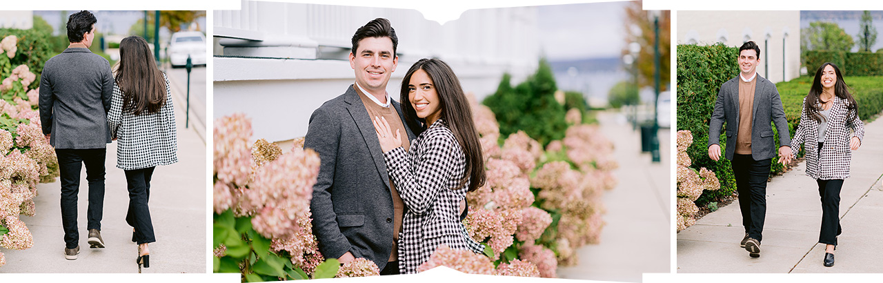 A man and woman walking on a sidewalk for downtown Petoskey engagement photography