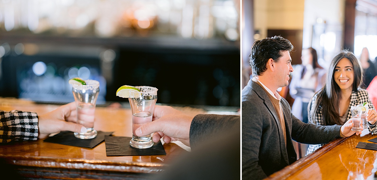 A man and woman smile at each other while toasting tequila in Petoskey