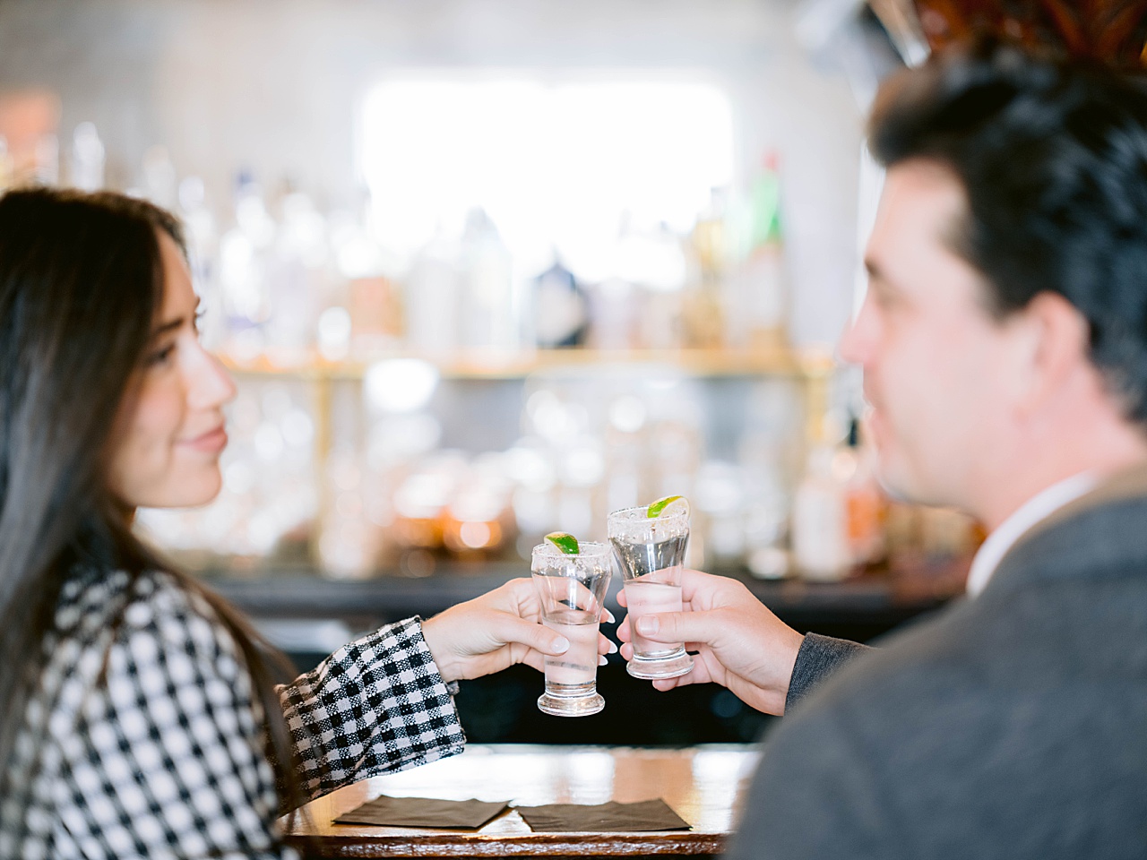A couple taking a shot at City Park Grill for engagement photos