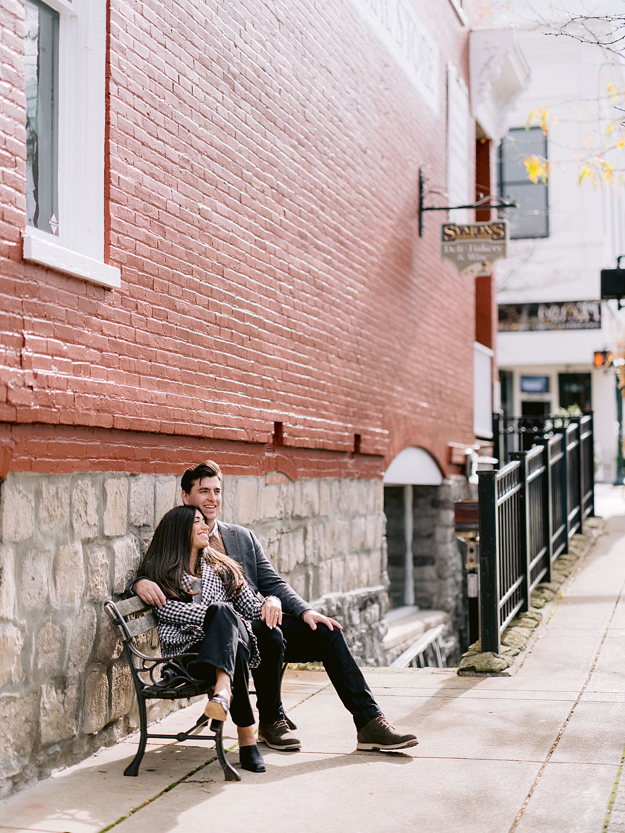 A man and woman sit beside each other on a bench in Petoskey Michigan