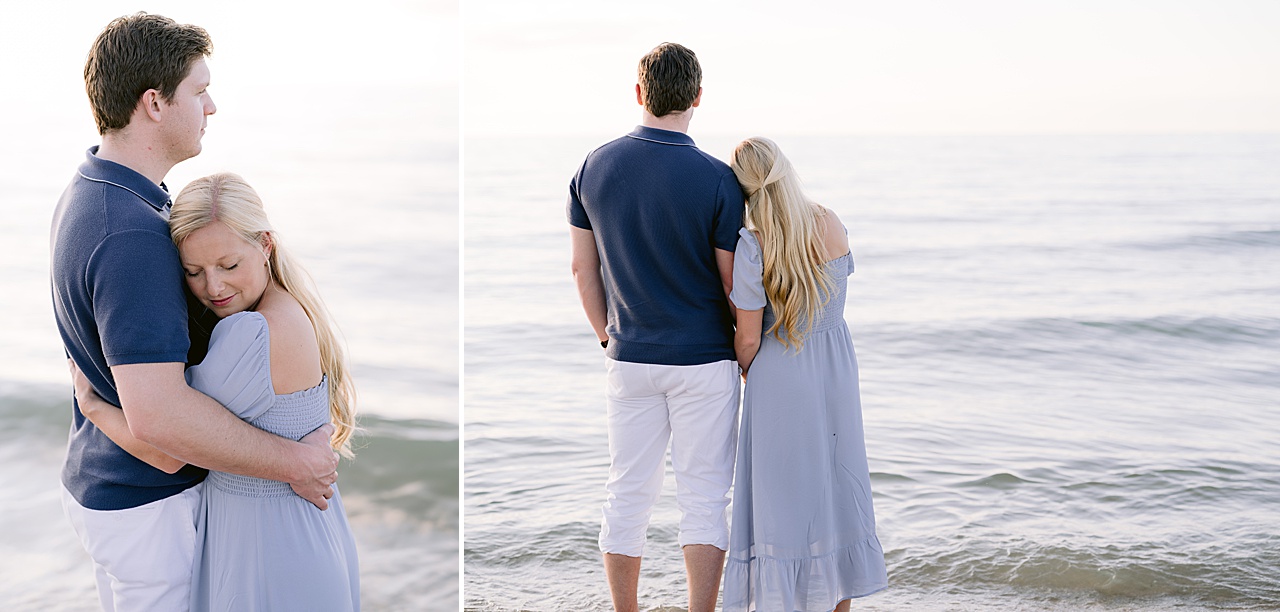 A woman hugging her fiancé with their toes in the lake and soaking in the moment