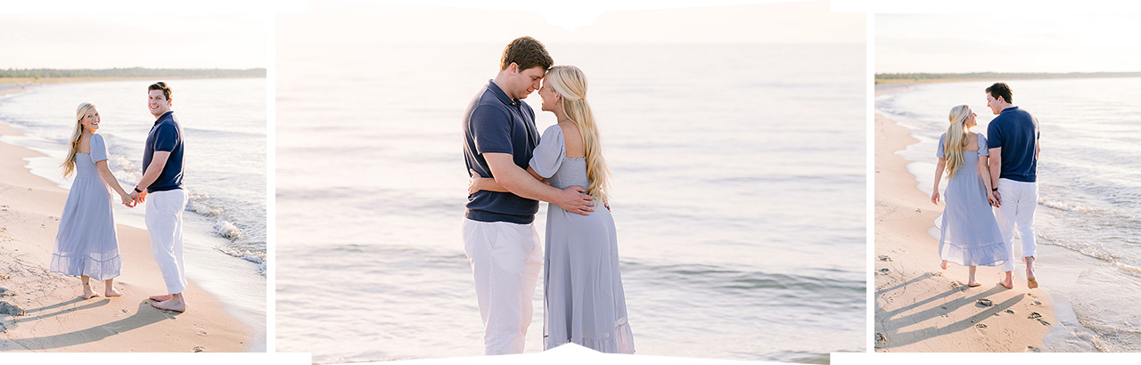 A couple walking down the lakeshore and looking back at the camera and smiling as the evening sunlight washes over them