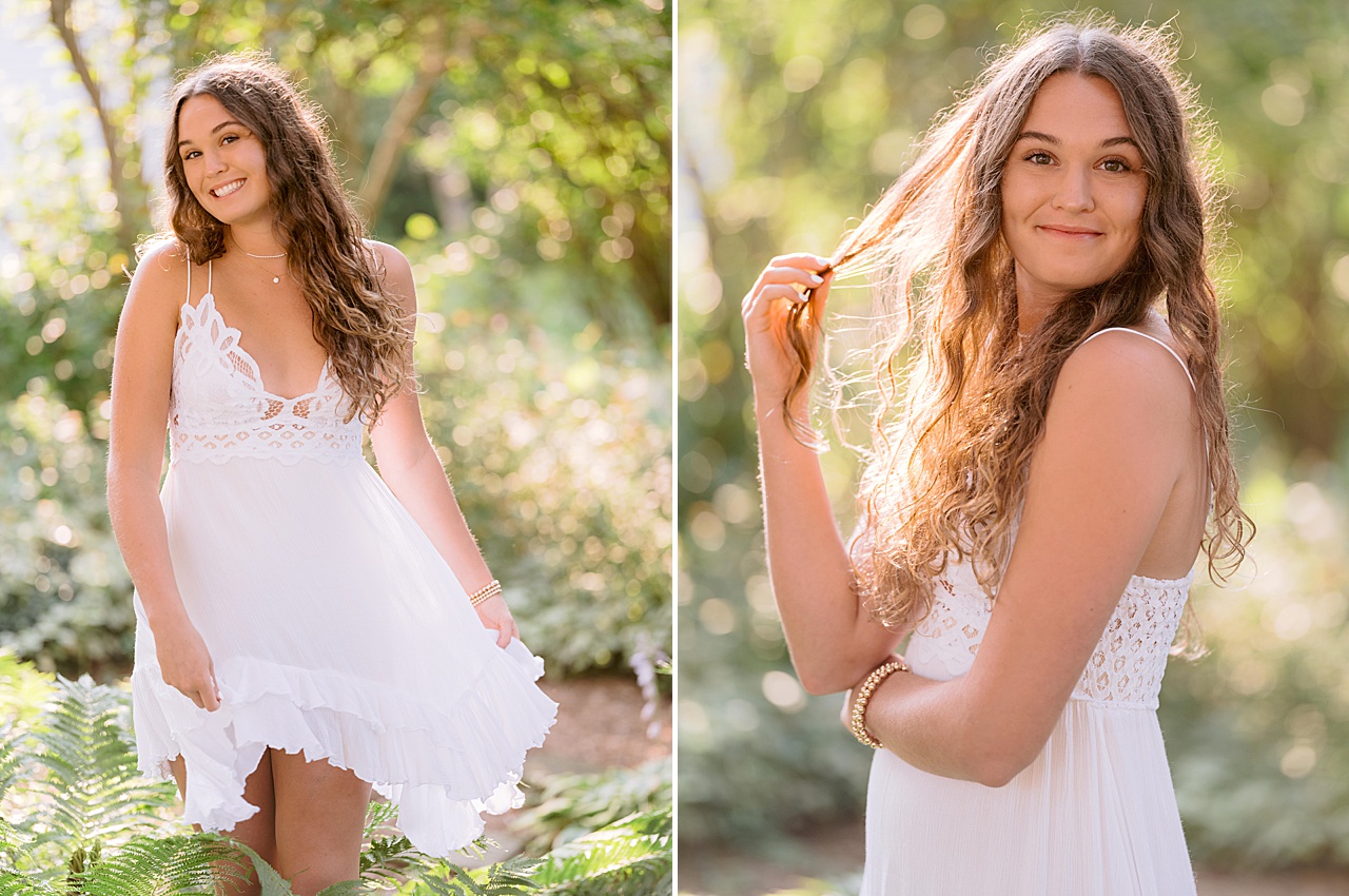 A senior girl poses for portraits in the shade near ferns in northern michigan