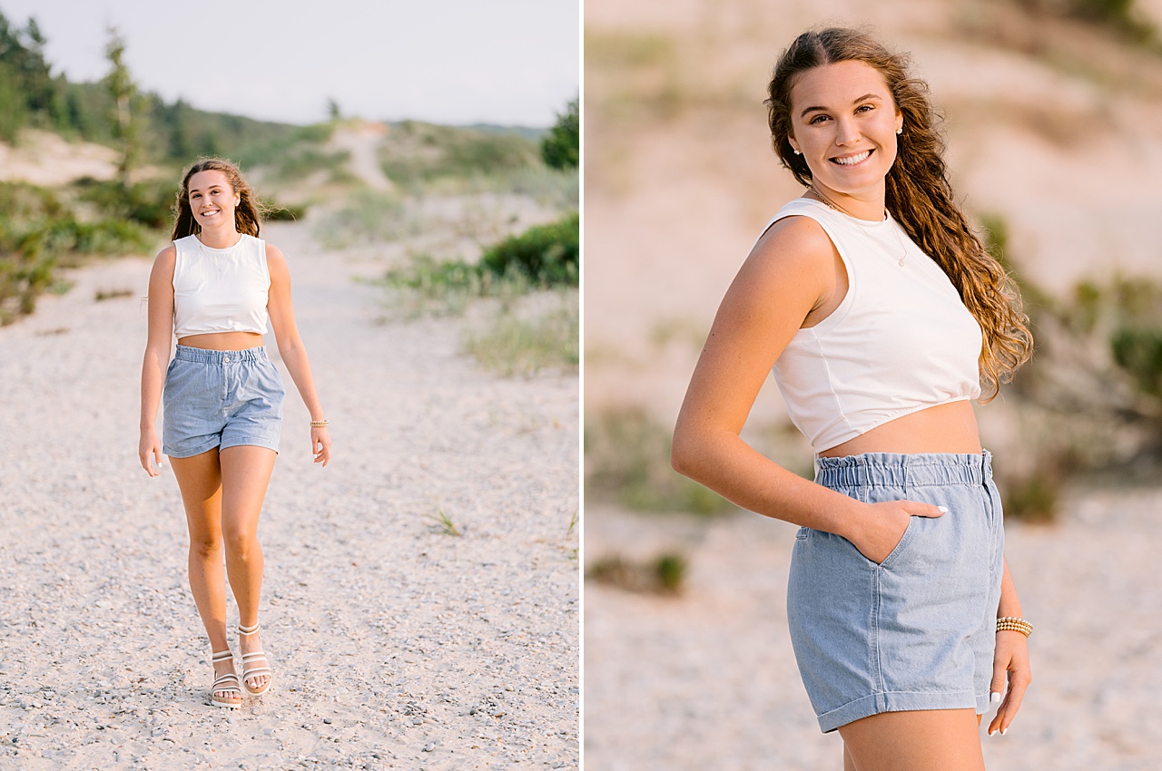 A high school senior stands with her hand in her pocket and smiles for senior pictures