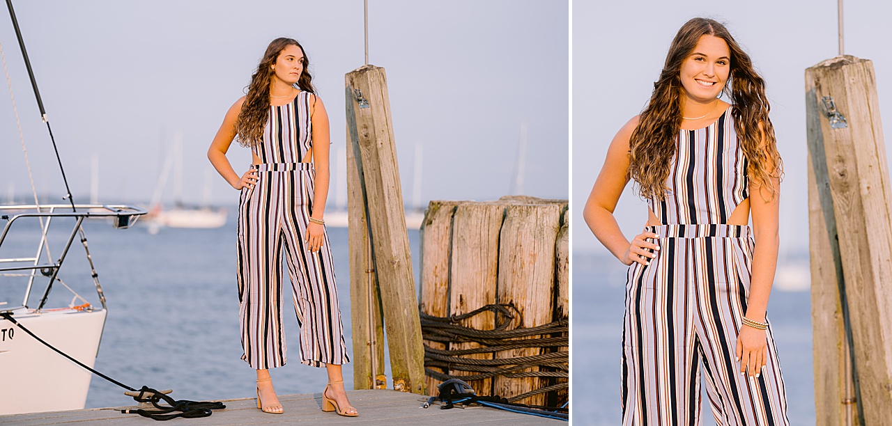 A high school senior girl poses on a dock in Northern Michigan for photos