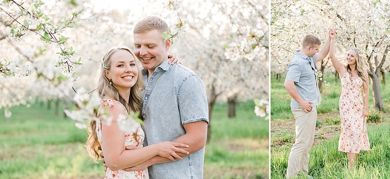 A couple poses for michigan cherry blossom engagement portraits in the spring