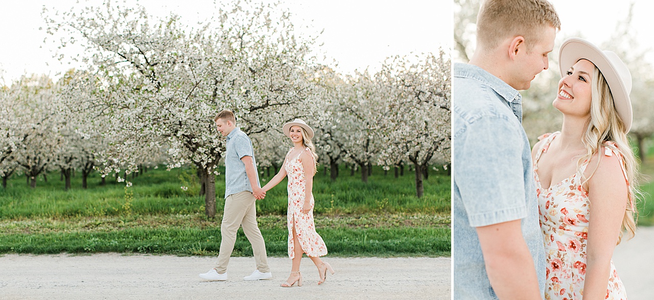 A woman looks up into the face of her fiancé and smiles for engagement portraits