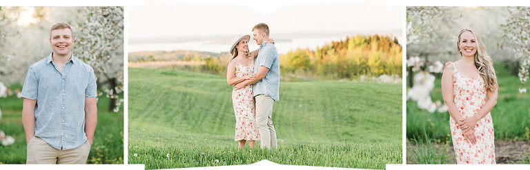 A couple smiling and holding each other stand at the top of hill with a gorgeous view