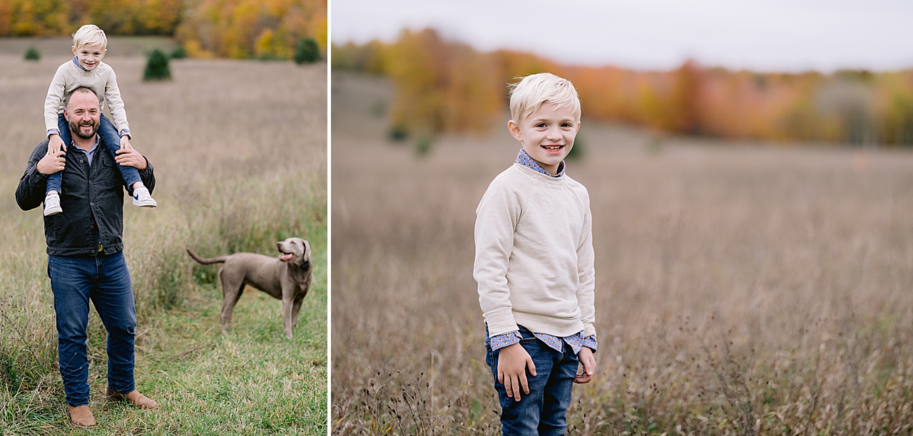 A man stands in a field in the fall with a young boy on his shoulders