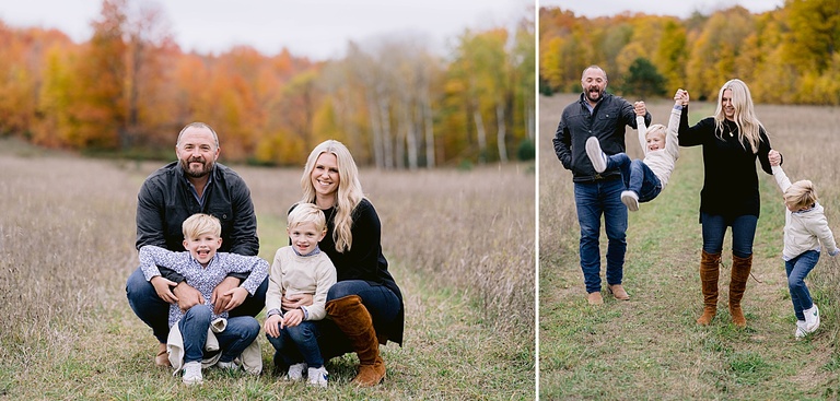 A family poses for michigan fall family portraits in a field with color changing trees
