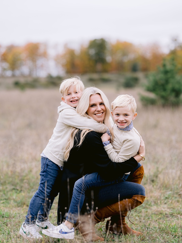 A mother poses with her two sons for michigan fall family portraits