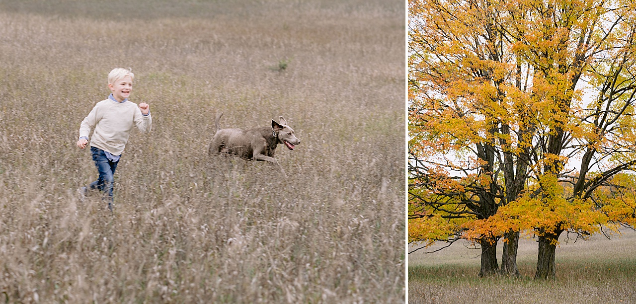 A young boy races through a field with his dog running beside him