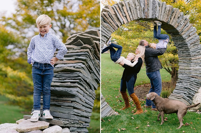 A mother and father help their sons walk upside down up an arch for michigan fall family portraits