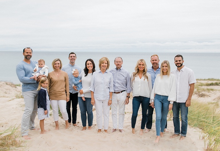 A family of 13 stand together on the beach somewhere in Northern Michigan