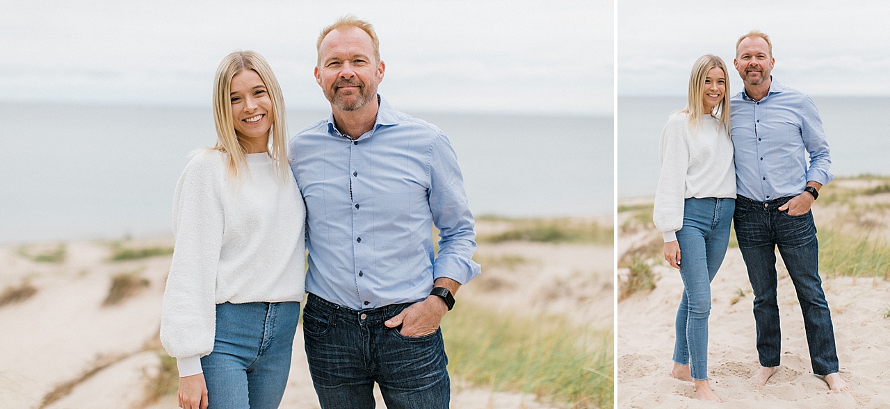 A girl poses with her father on a Northern Michigan beach for family portraits