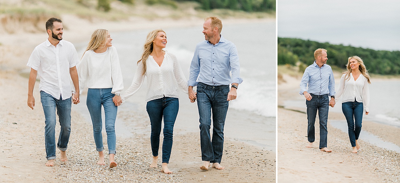 A family dressed in white and blue walks up a beach in Northern Michigan