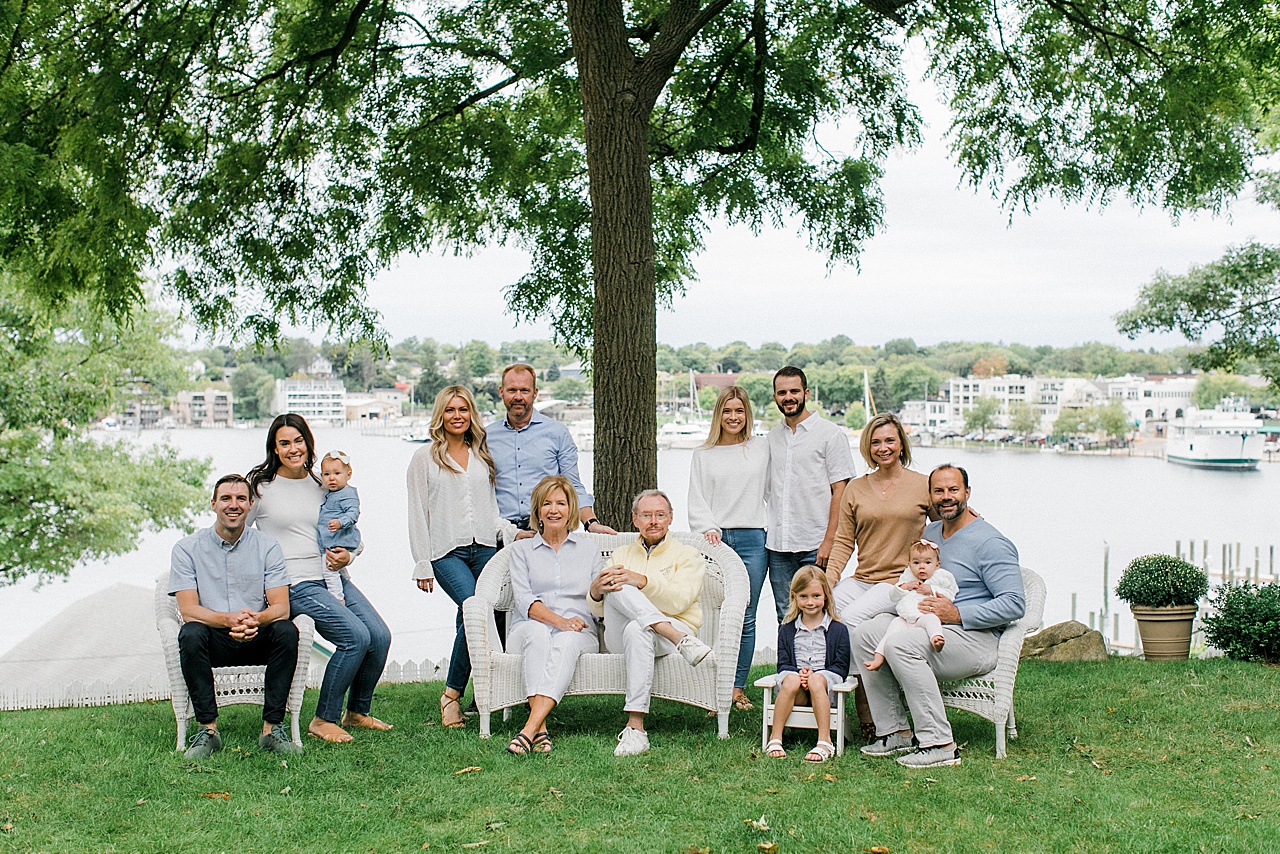 A family poses for Northern Michigan family portraits while sitting on lawn furniture