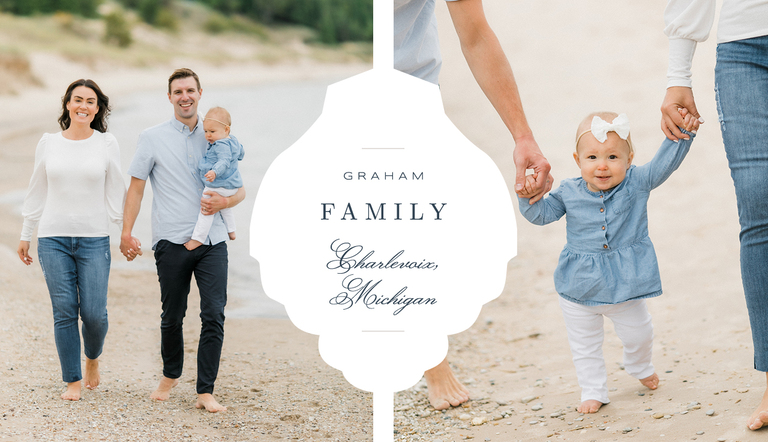 A mother and father walking down a sandy beach white holding their young daughters hands